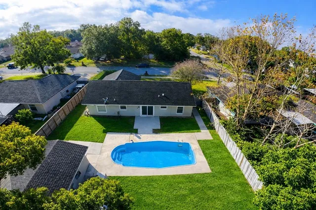 an aerial view of house with yard swimming pool and outdoor seating