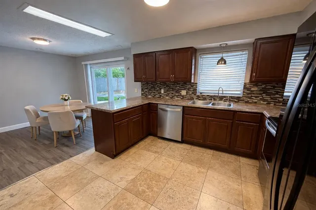 a kitchen with stainless steel appliances granite countertop a sink stove and cabinets