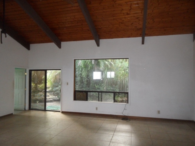 120 Peahi Road Haiku, HI 96708 - Photo 12 of 26 an empty room with wooden floor and windows