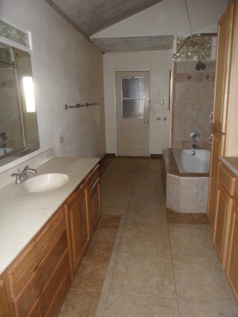 120 Peahi Road Haiku, HI 96708 - Photo 16 of 26 a spacious bathroom with a double vanity sink a mirror and a bathtub