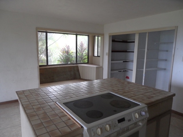 120 Peahi Road Haiku, HI 96708 - Photo 6 of 26 a kitchen with a stove and a kitchen island