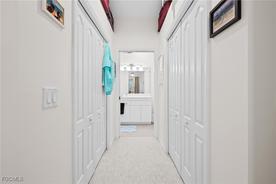 14217 Prim Point Lane Fort Myers, FL 33919 - Photo 19 of 46 a view of a hallway with wooden floor and entryway