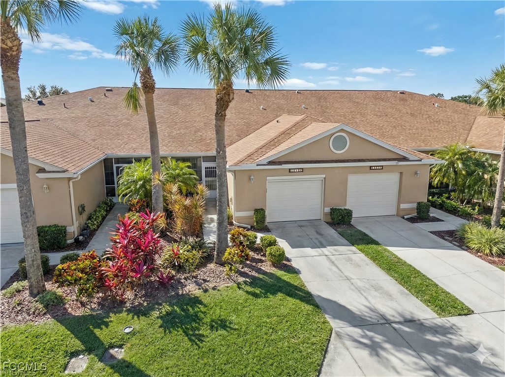 14217 Prim Point Lane Fort Myers, FL 33919 - Photo 3 of 46 a front view of a house with a yard and potted plants