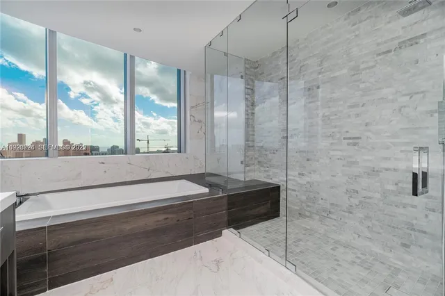 a large bathroom with a large tub and sink