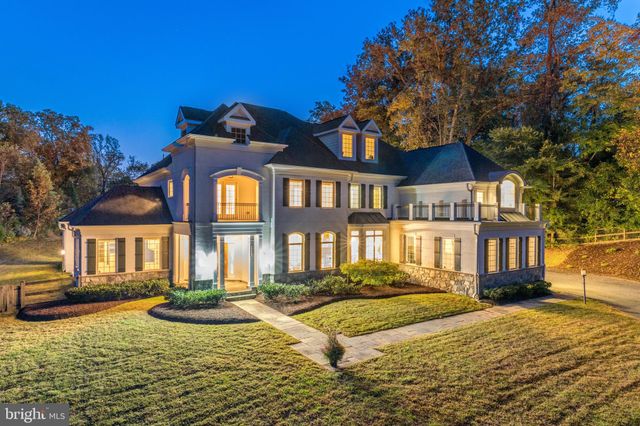 a front view of a house with yard and trees