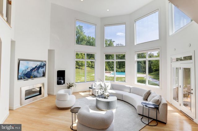 a living room with furniture a fireplace and a large window