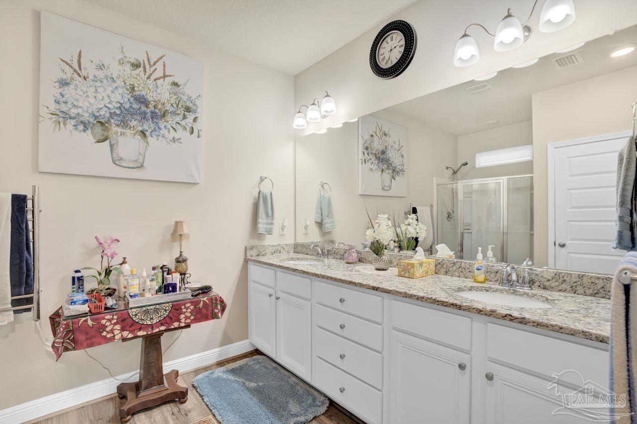 5364 Red Shoulder Road Pace, FL 32571 - Photo 37 of 46 a bathroom with a granite countertop sink a mirror and vanity