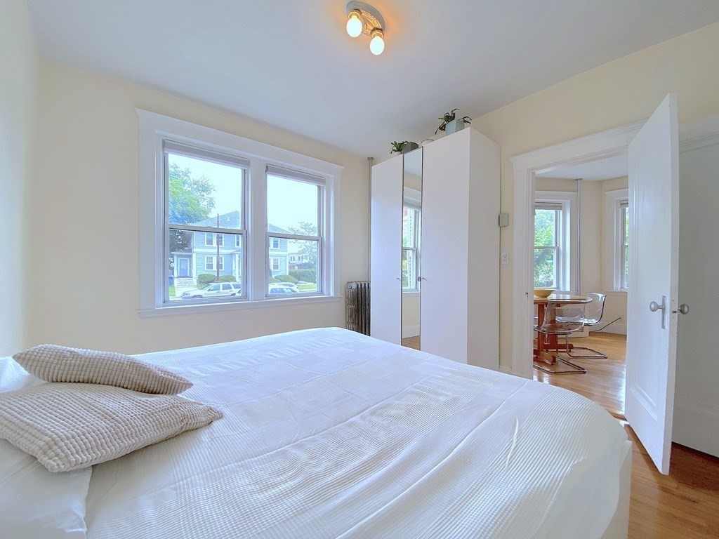 91 Bynner Street, Unit 1 Boston, MA 02130 - Photo 12 of 35 a bedroom with a bed and a couch next to a window