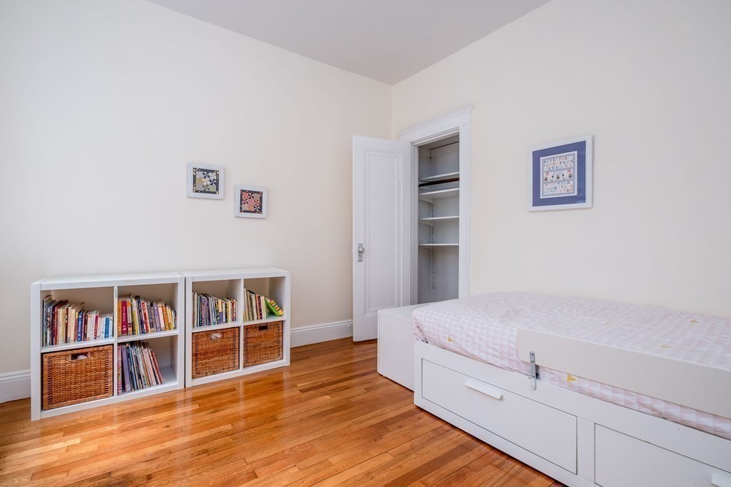 91 Bynner Street, Unit 1 Boston, MA 02130 - Photo 15 of 35 a room with a bed and a book shelf