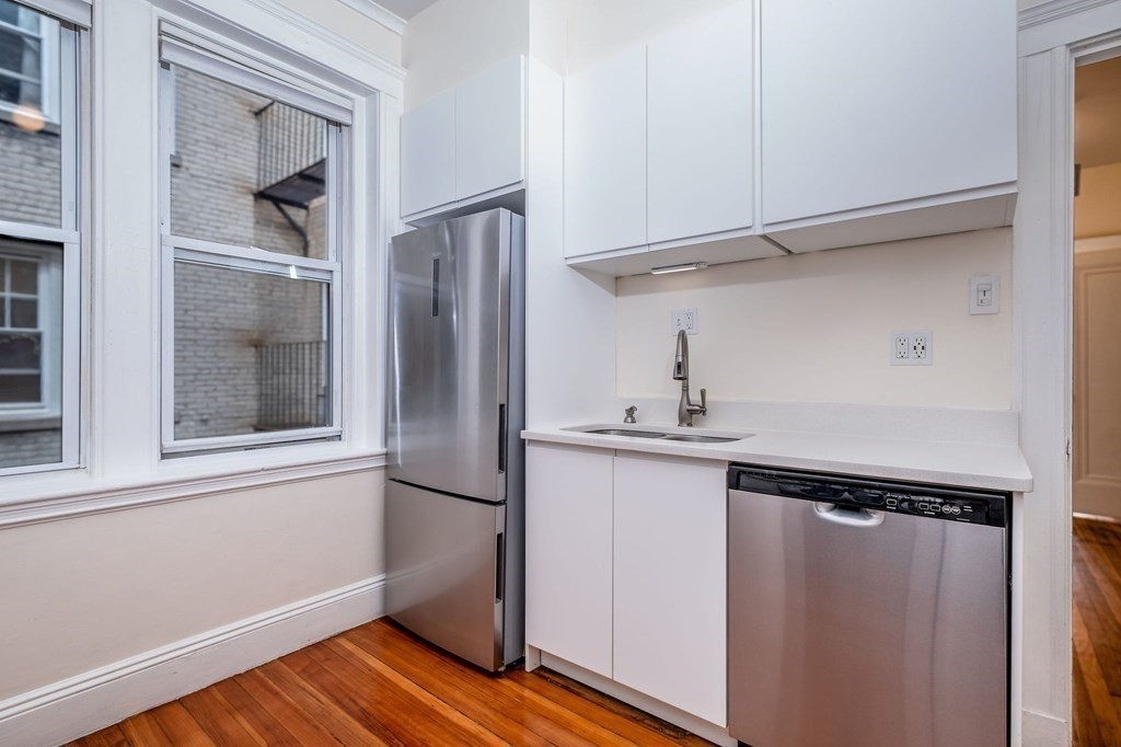 91 Bynner Street, Unit 1 Boston, MA 02130 - Photo 8 of 35 a kitchen with a refrigerator and a sink