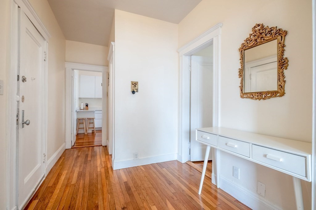 91 Bynner Street, Unit 1 Boston, MA 02130 - Photo 9 of 35 a view of a hallway with wooden floor and a bathroom