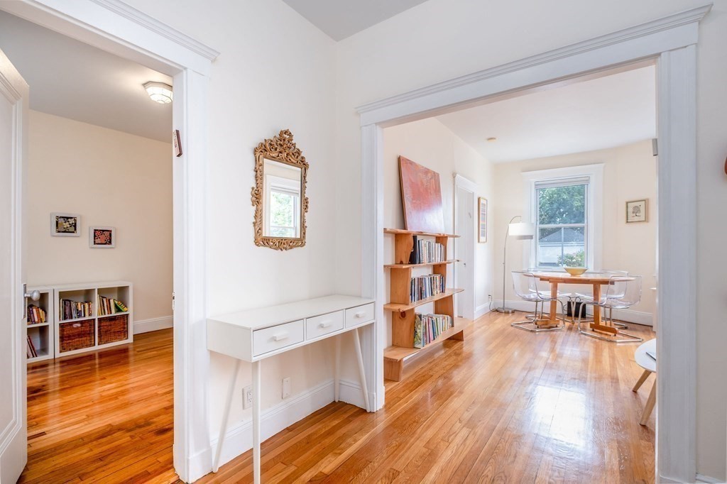 91 Bynner Street, Unit 1 Boston, MA 02130 - Photo 10 of 35 a view of a living room and dining room with wooden floor