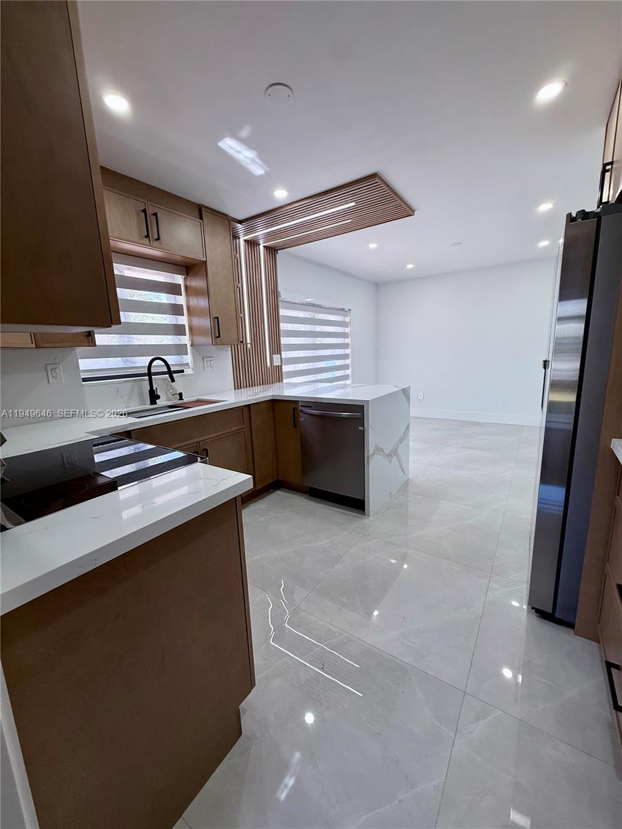 15235 Southwest 108th Court Miami, FL 33157 - Photo 12 of 25 a kitchen with stainless steel appliances a sink and a refrigerator