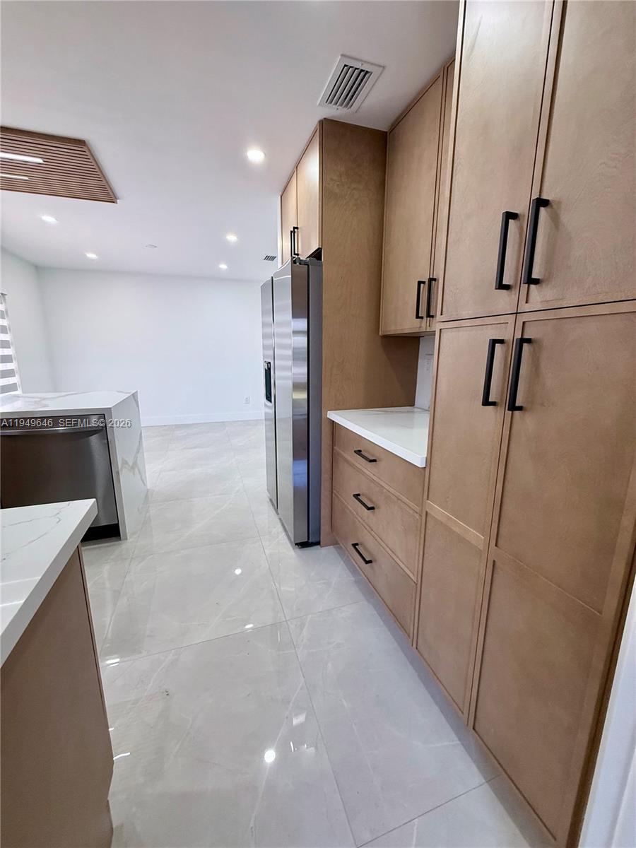 15235 Southwest 108th Court Miami, FL 33157 - Photo 14 of 25 a view of a kitchen with furniture and a refrigerator