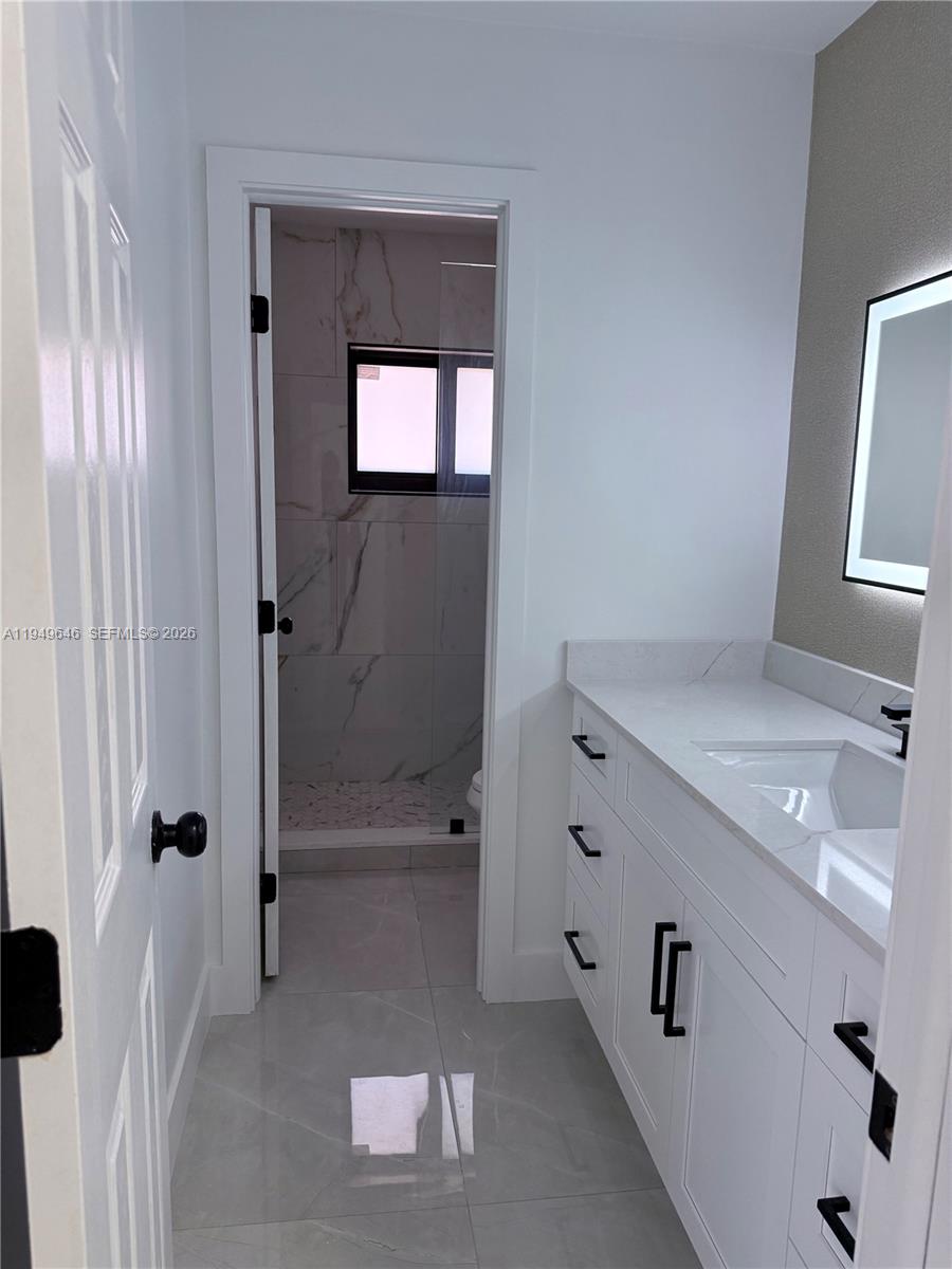 15235 Southwest 108th Court Miami, FL 33157 - Photo 18 of 25 a bathroom with a sink a toilet and shower