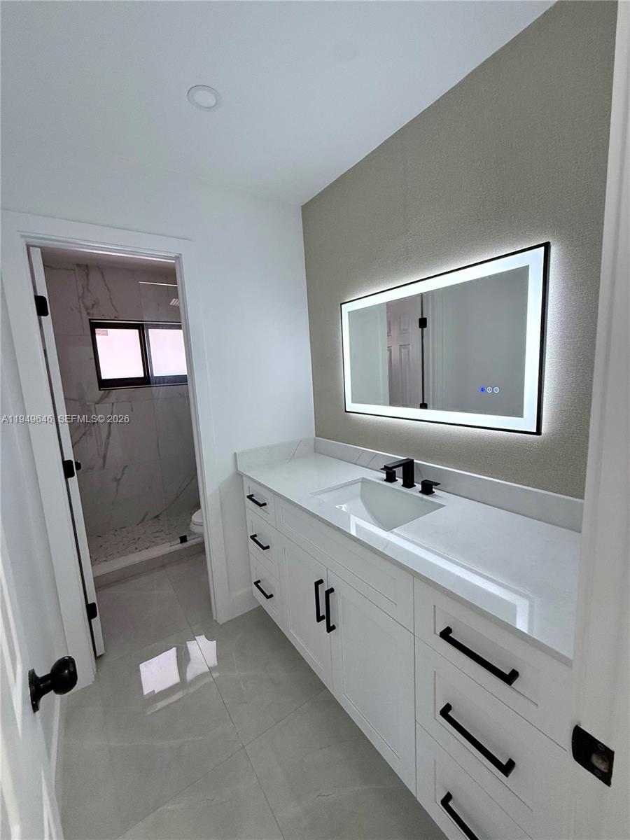 15235 Southwest 108th Court Miami, FL 33157 - Photo 19 of 25 a bathroom with a double vanity sink mirror and toilet