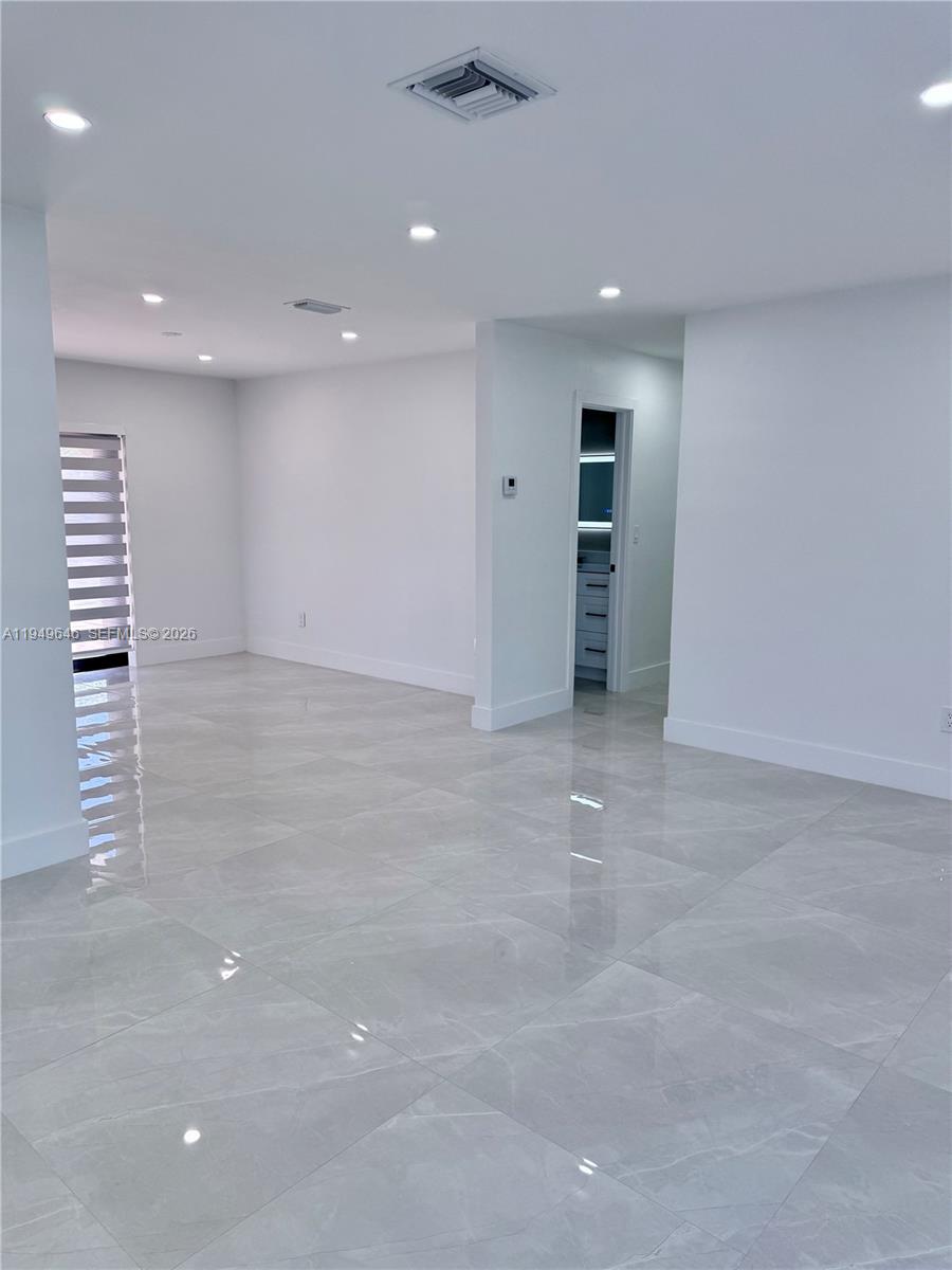 15235 Southwest 108th Court Miami, FL 33157 - Photo 6 of 25 a view of an empty room with a kitchen