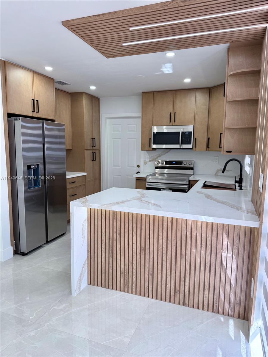 15235 Southwest 108th Court Miami, FL 33157 - Photo 10 of 25 a kitchen with stainless steel appliances a refrigerator and a stove top oven
