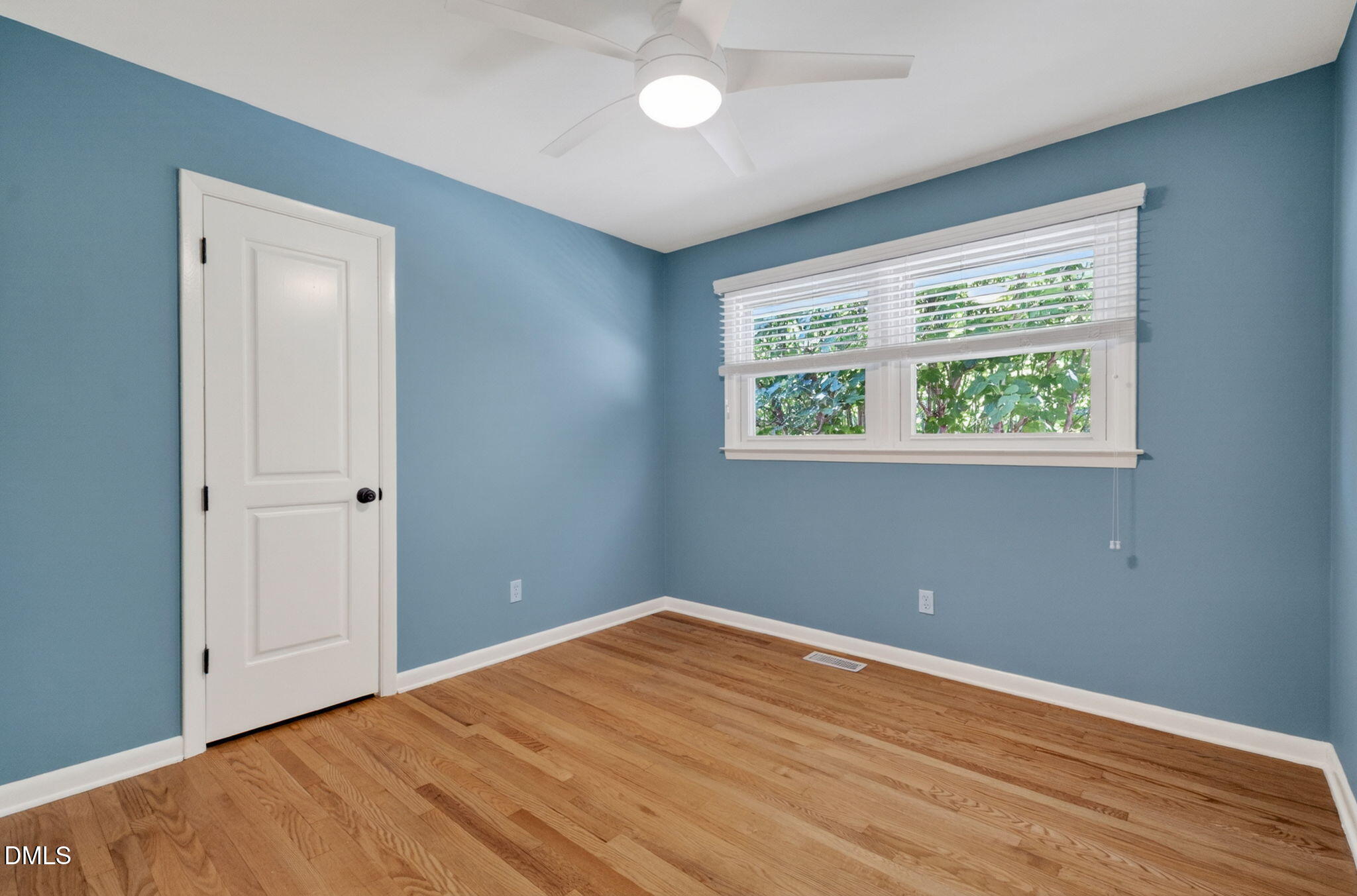1224 Pineview Drive Raleigh, NC 27606 - Photo 16 of 45 a view of an empty room with wooden floor and a window