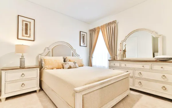 a bedroom with a bed and a dresser