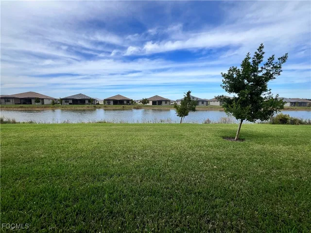 a view of a lake with houses in the back