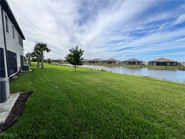 a view of a lake with houses in the back