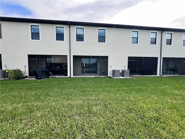 a view of house with yard and front view of a house