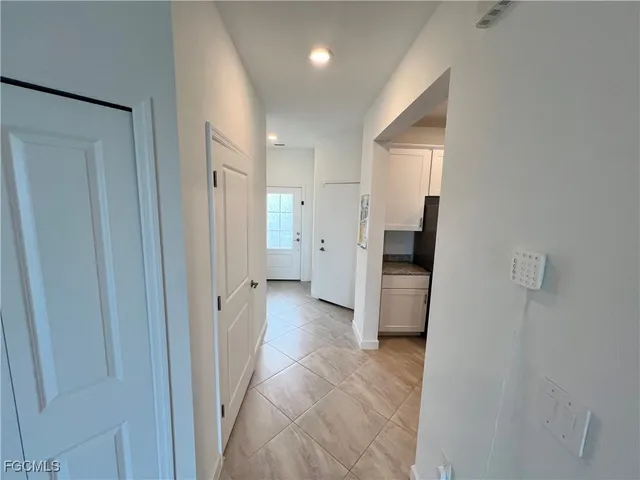 a view of a hallway with a refrigerator