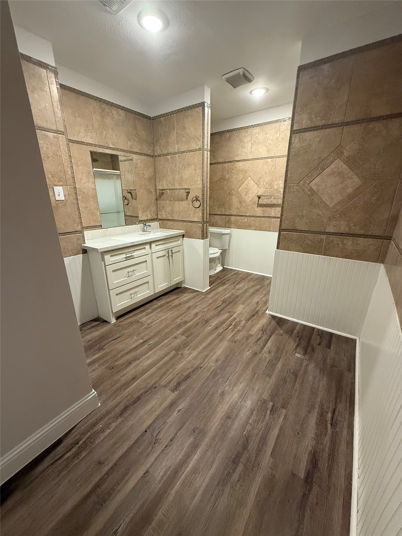 320 Delaware Street Houston, TX 77029 - Photo 5 of 10 a large kitchen with kitchen island a sink wooden floor and a counter top space