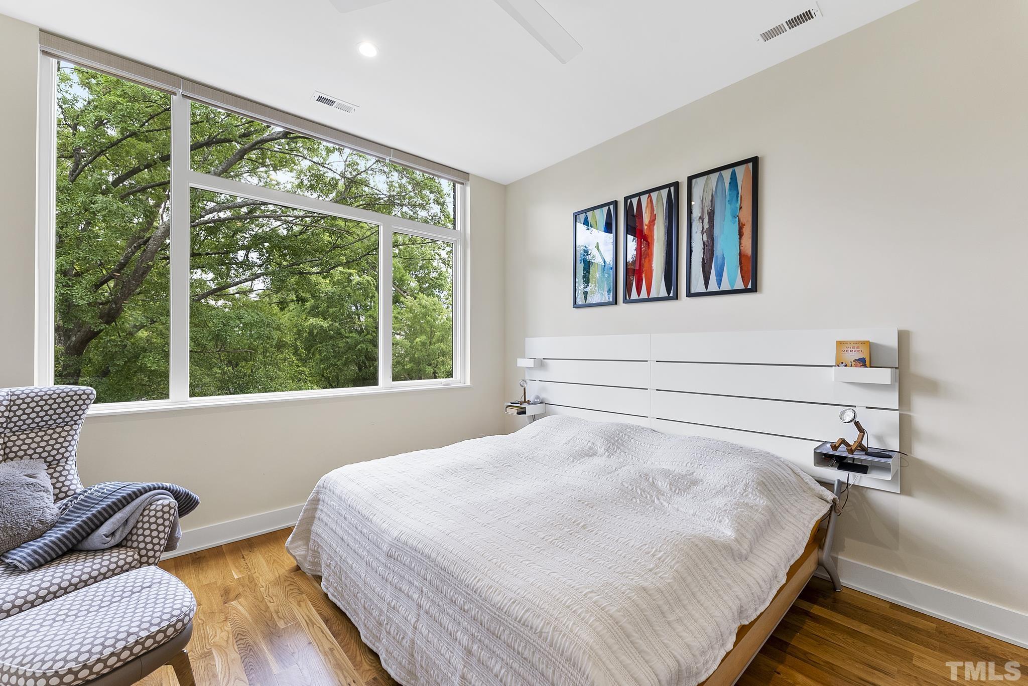 2323 Clark Avenue Raleigh, NC 27607 - Photo 17 of 33 a bedroom with a bed and a large window with the outer view