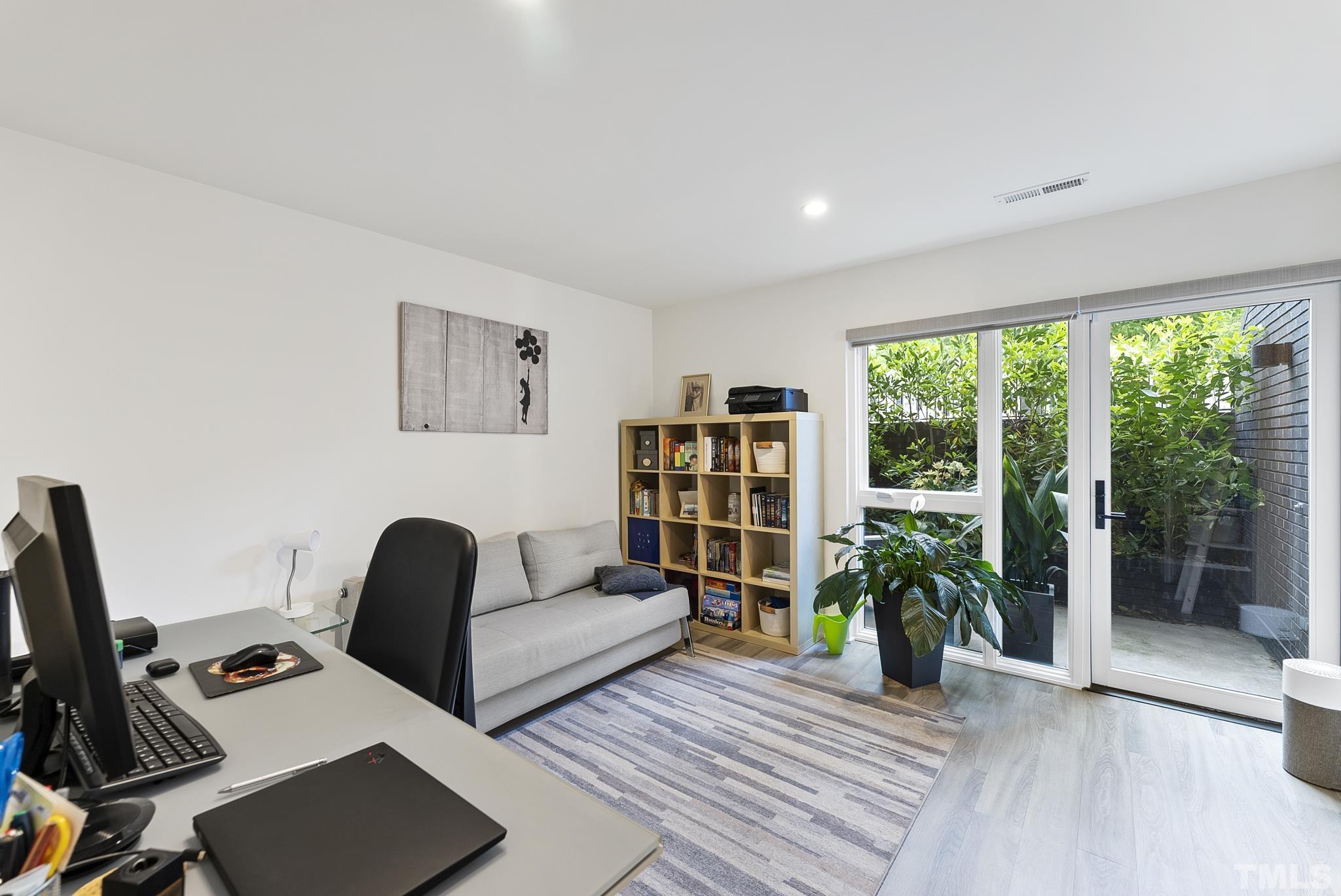 2323 Clark Avenue Raleigh, NC 27607 - Photo 25 of 33 a view of a workspace with furniture and a potted plant