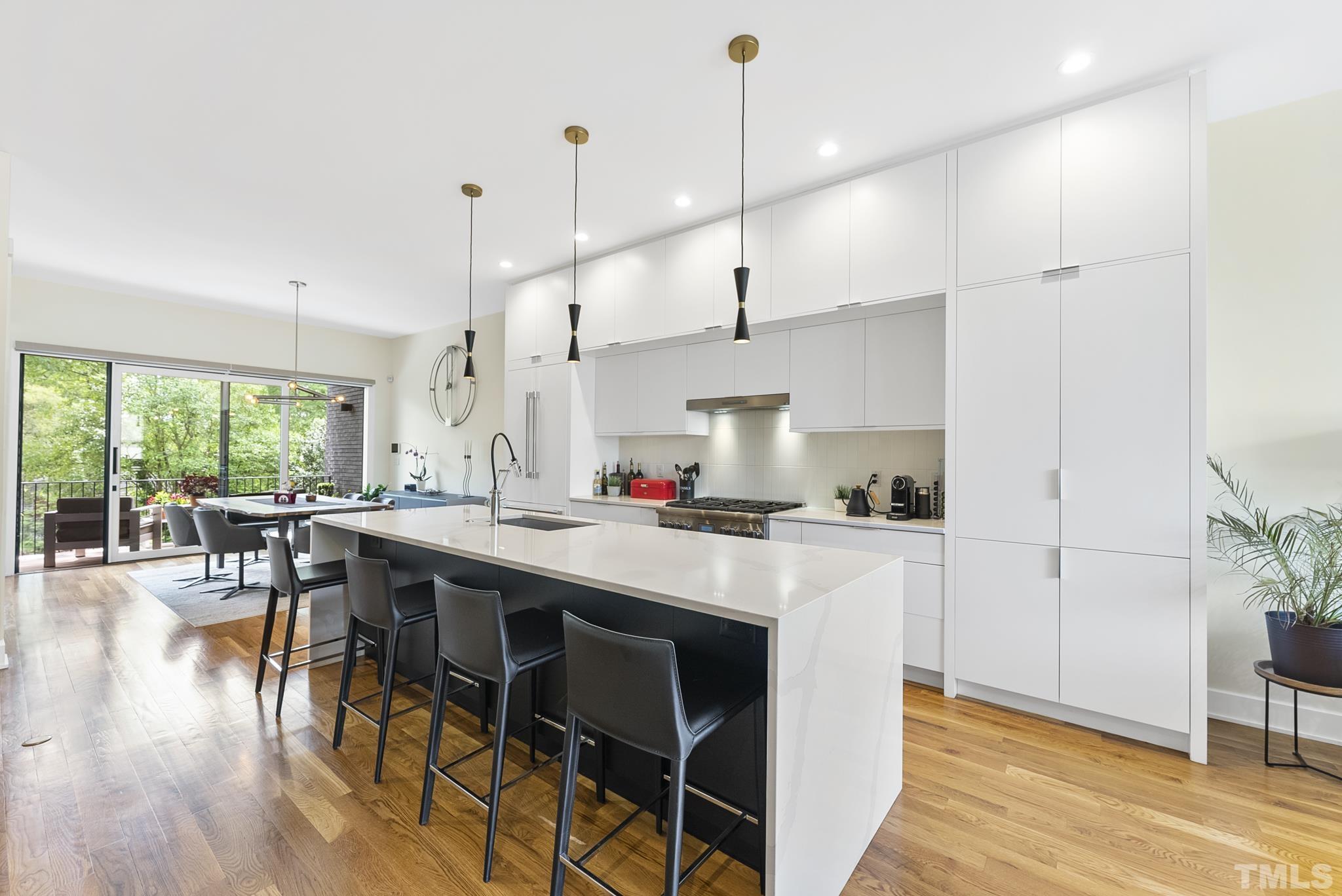 2323 Clark Avenue Raleigh, NC 27607 - Photo 7 of 33 a kitchen with a table chairs stove and wooden floor
