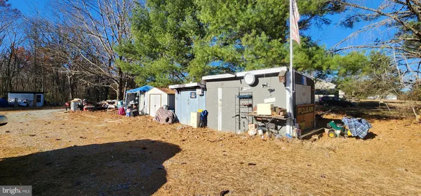 a view of a yard with snow on the road