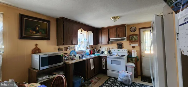 a kitchen with a sink appliances and cabinets