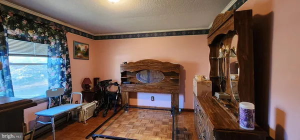 a view of a living room with furniture and a mirror
