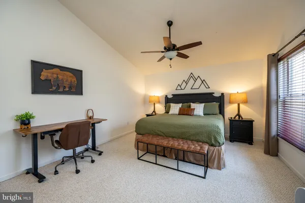 a bedroom with two beds and a chandelier