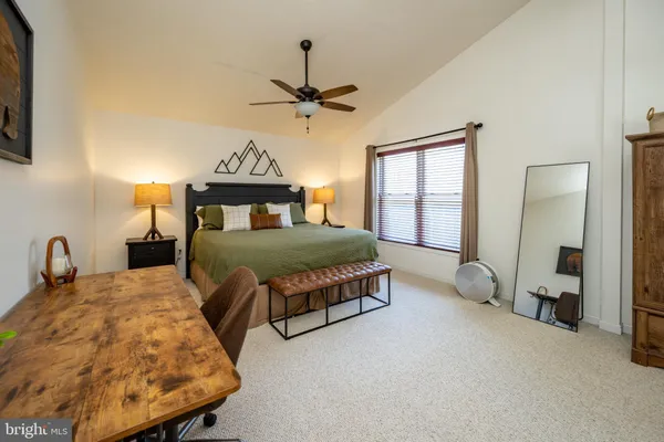 a bedroom with double bed and a flat screen tv