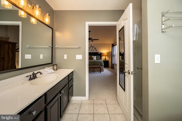 a bathroom with a sink a toilet and shower curtain