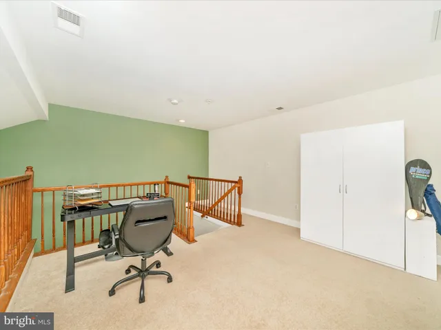 a bedroom with a bed and dresser with mirror