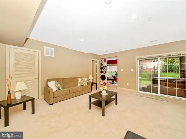 a room with furniture a flat screen tv and a window