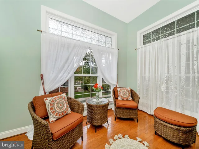 a living room with furniture a rug and a window