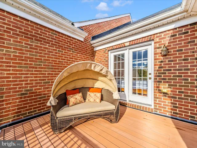 a view of balcony with wooden floor and outdoor seating