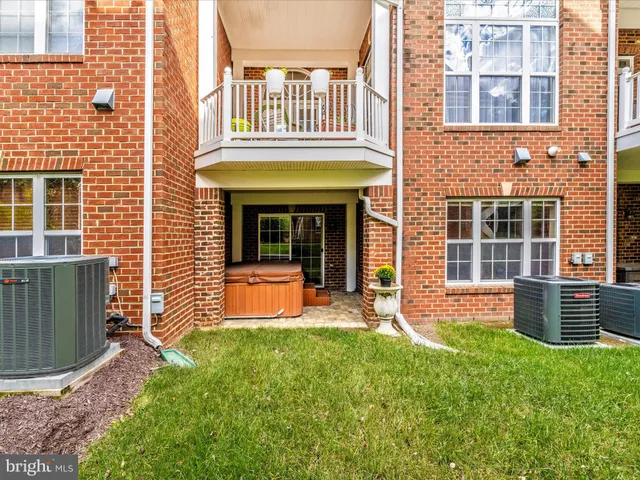 a view of a brick building next to a yard