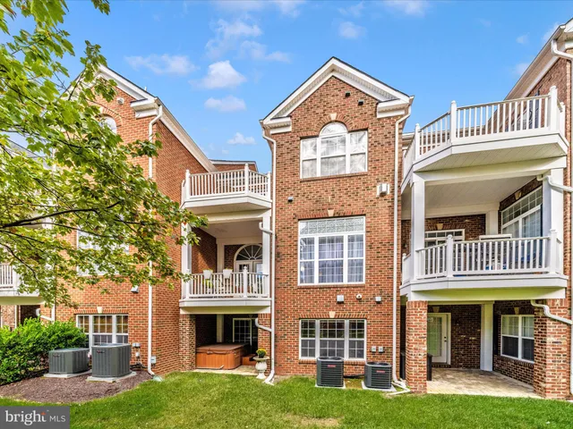 a front view of a residential apartment building with a yard