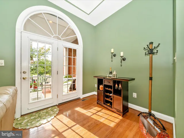 a dining room with furniture a chandelier and wooden floor