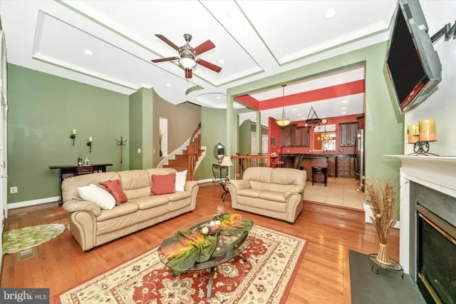 a dining room with furniture a fireplace and large windows