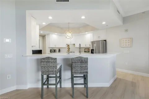 a kitchen with stainless steel appliances kitchen island granite countertop a sink and cabinets
