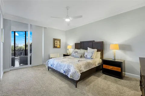 a bedroom with a bed lamp and a fireplace