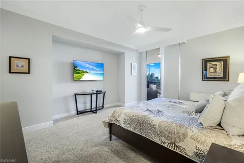 a bedroom with a bed a painting on the wall and a dresser