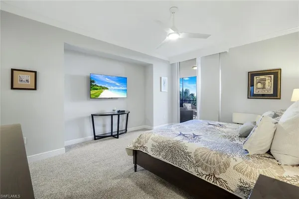 a bedroom with a bed a painting on the wall and a dresser